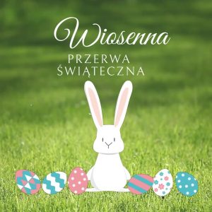 Na zielonym tle trawy biały zajączek  i 6 kolorowych pisanek